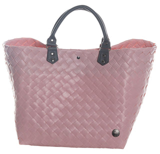 Der Witzgall Shopper Klassik 5110 ist eine rosa gewebte Tragetasche mit schwarzen Kunstledergriffe und einem kleinen runden Metallemblem in der unteren rechten Ecke, ideal für Liebhaber trendiger Farben.