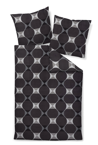 Janine Bettwäsche Mako-Satin J.D. 87103 von Janine zeigt ein schwarz-graues geometrisches Muster mit großen Kreisen aus luxuriösem Mako-Baumwolle-Stoff.